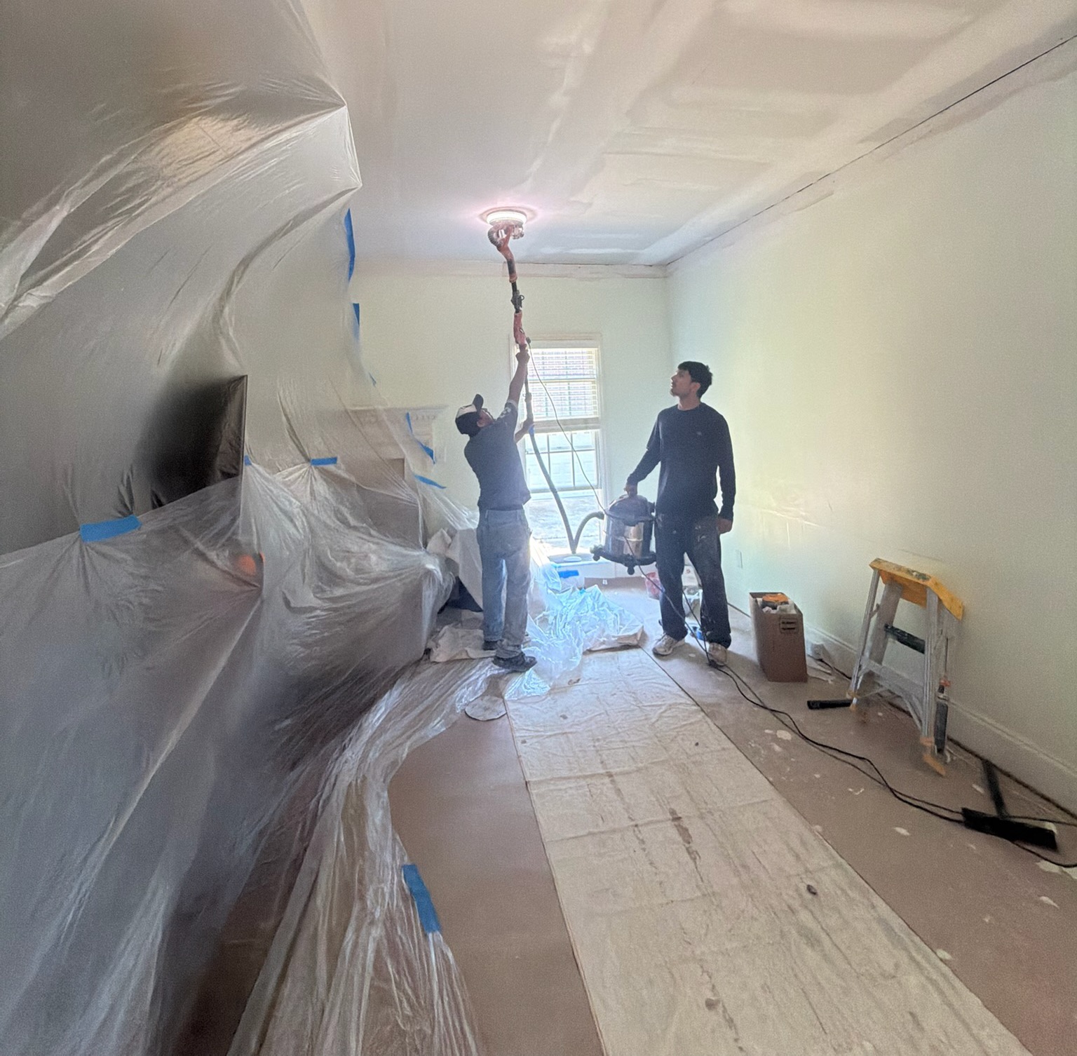 A&S Painting & Remodeling crew painting a ceiling in a protected home interior